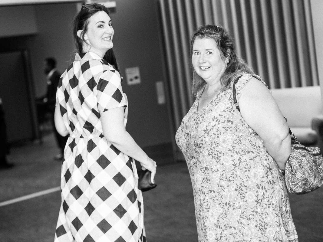 A series of black and white candid photos showing joyful moments at an indoor gathering.