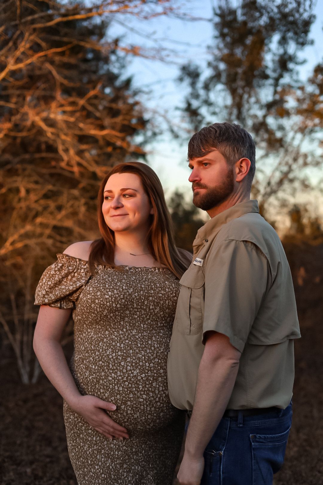 Maternity picture of a couple in a field. Marianna Florida photography.