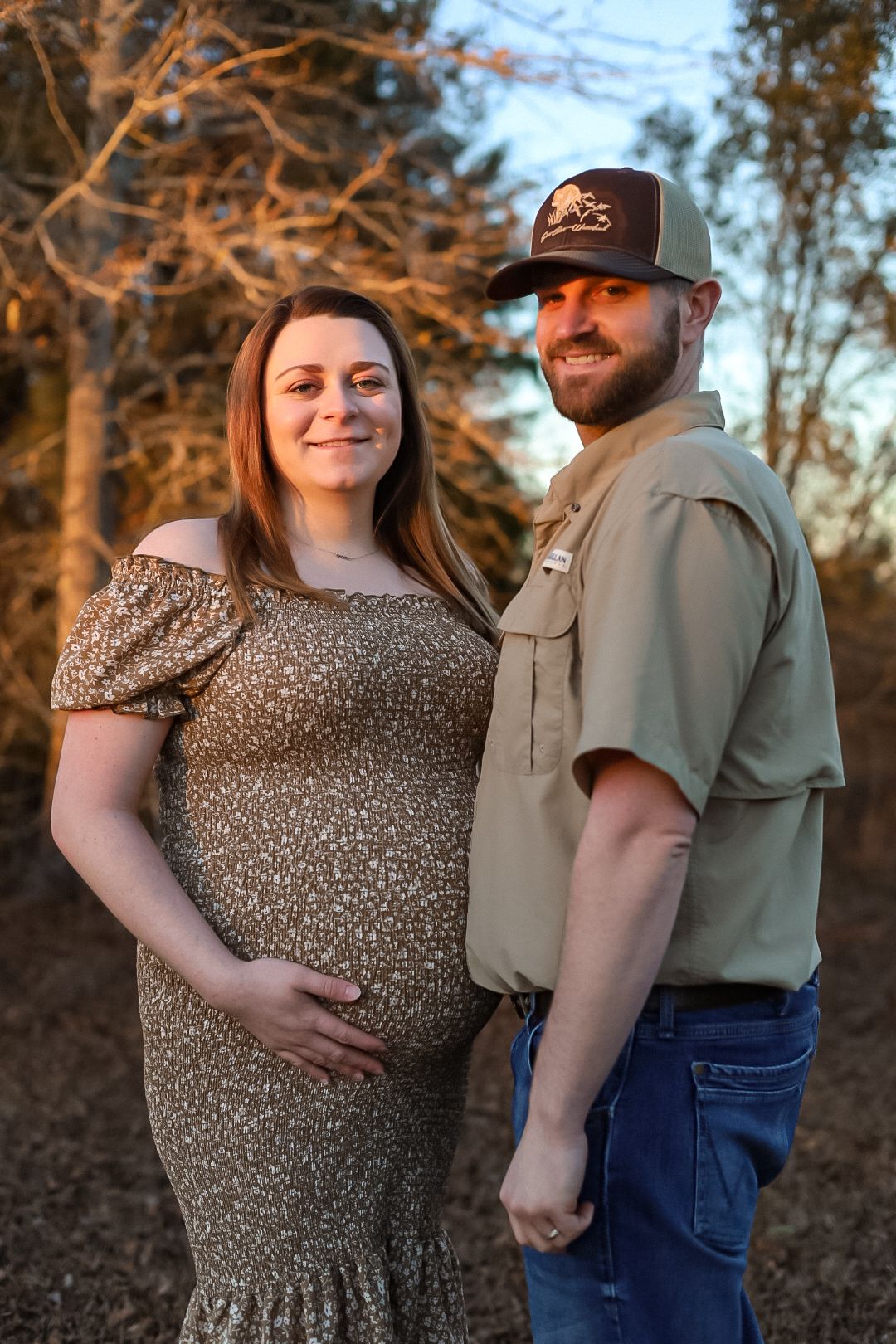 Maternity picture of a couple in a field. Marianna Florida photography.
