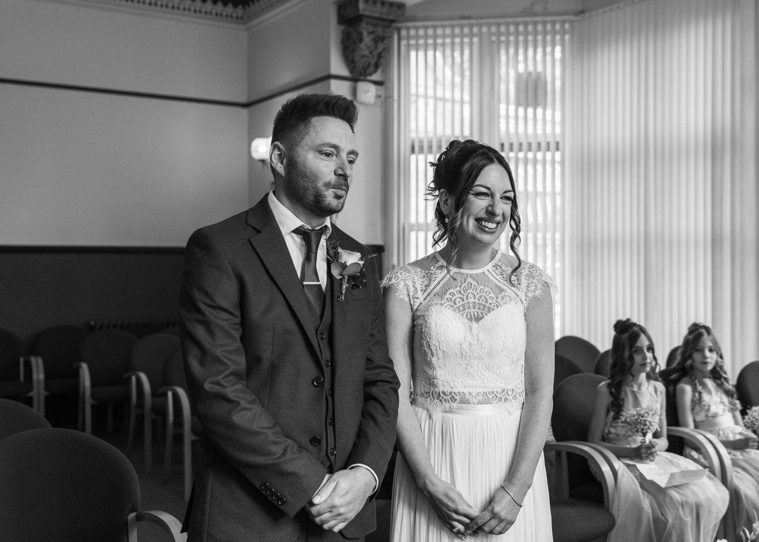 A bride and groom sharing a romantic moment during their ceremony, captured by EvieSJPhotography.