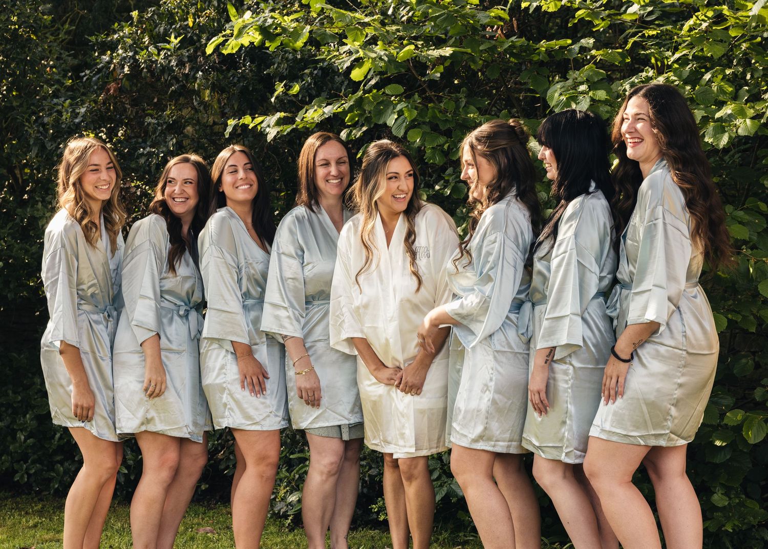 A bride and her bridesmaids, having fun during morning prep before the wedding begins, captured by EvieSJPhotography.