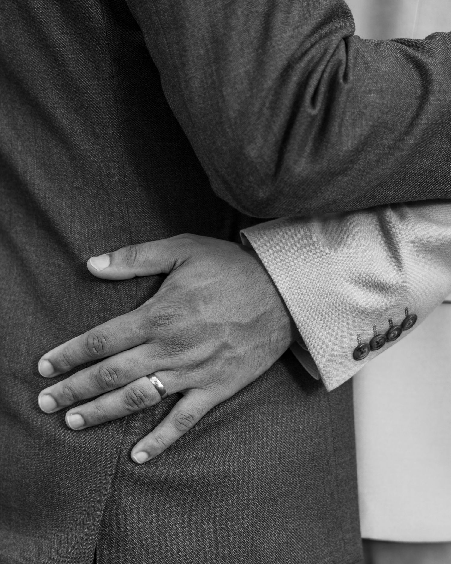 Aaron and Jack share a quiet embrace during golden-hour wedding portraits at Rock Village Hall.