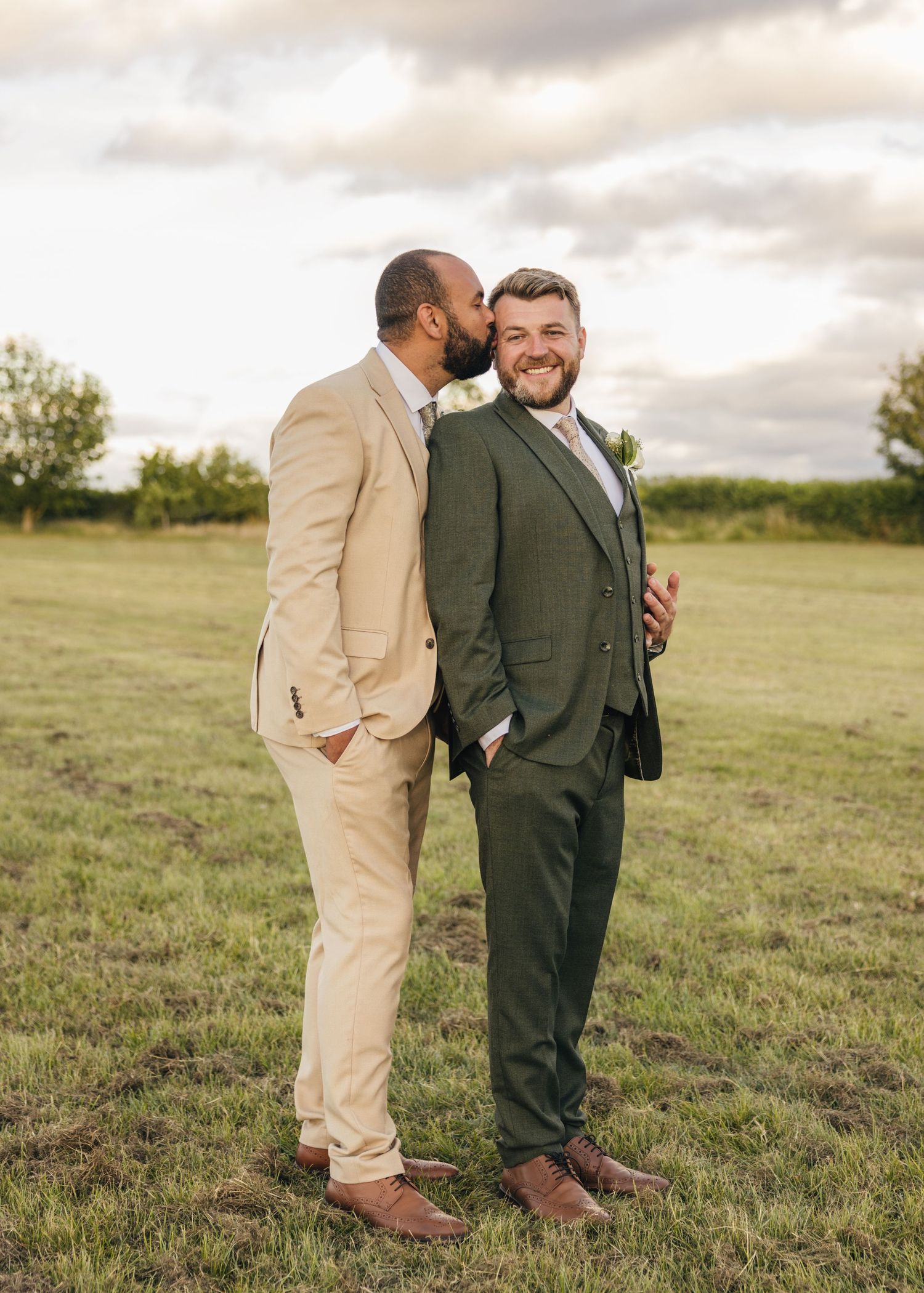 Aaron kissing Jack on the cheek during couple portraits at a Worcestershire wedding.