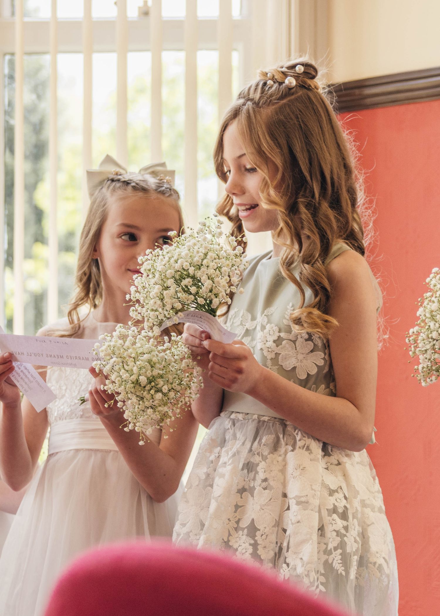 Bridesmaids reading a poem during their parents wedding ceremony, captured by EvieSJPhotography.