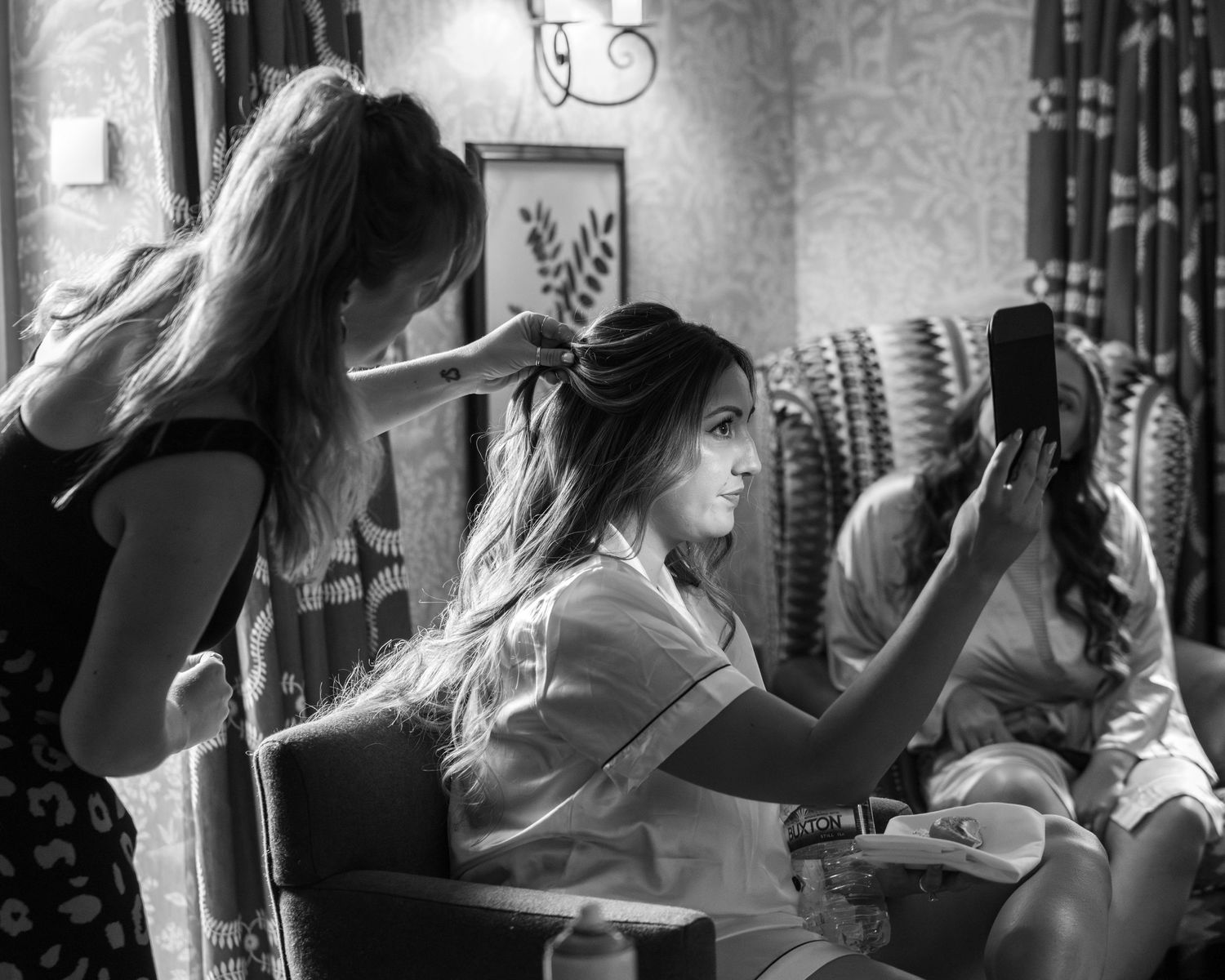 Bride having her hair done on her wedding day.