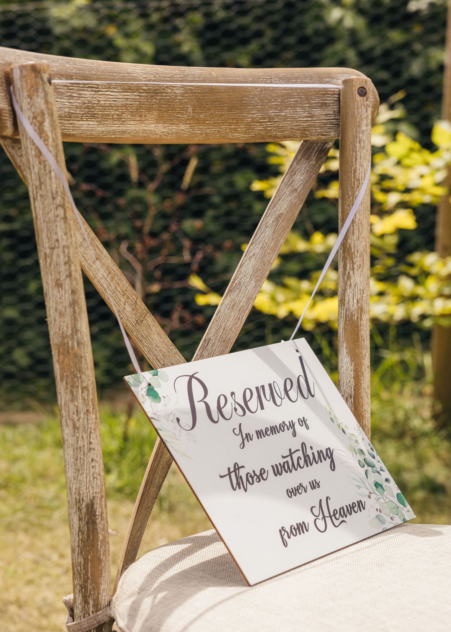 A beautiful reserved chair for those watching on the wedding ceremony from heaven.