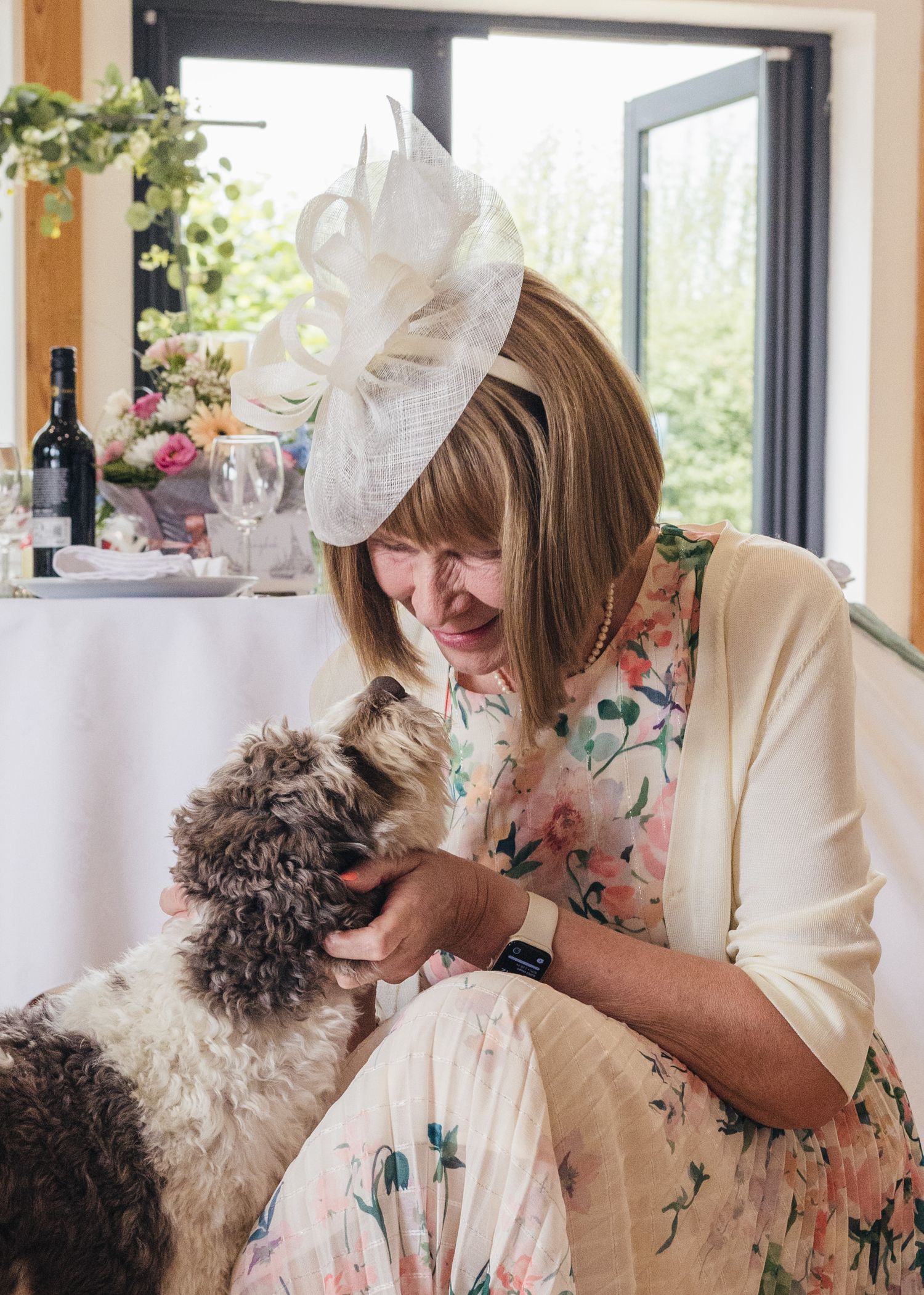 A lady sharing a special moment with Milo the dog at a wedding in Worcestershire.