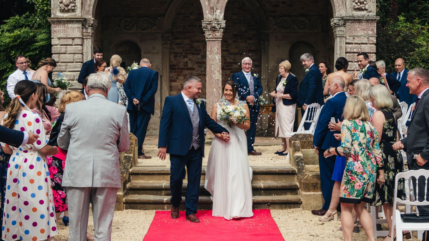 Bride and groom walking down the aisle post-ceremony, captured by EvieSJPhotography.