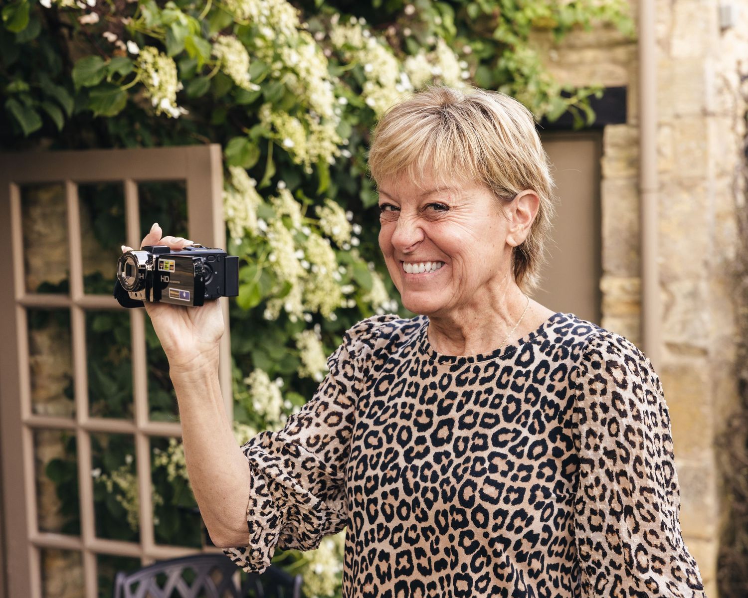 Mother of the groom filming special moments on a camcorder.