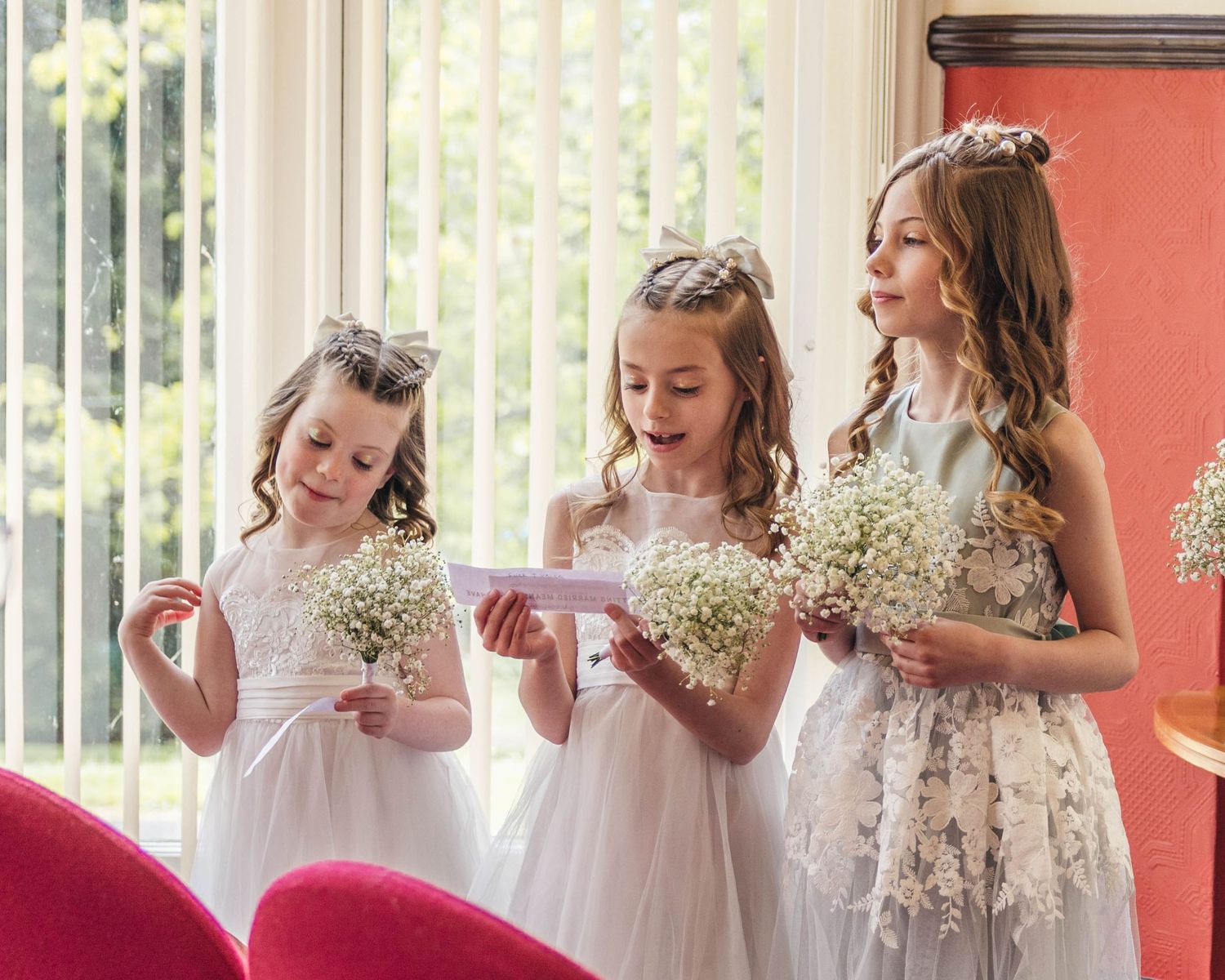Bridesmaids reading a poem during their parents wedding ceremony, captured by EvieSJPhotography.