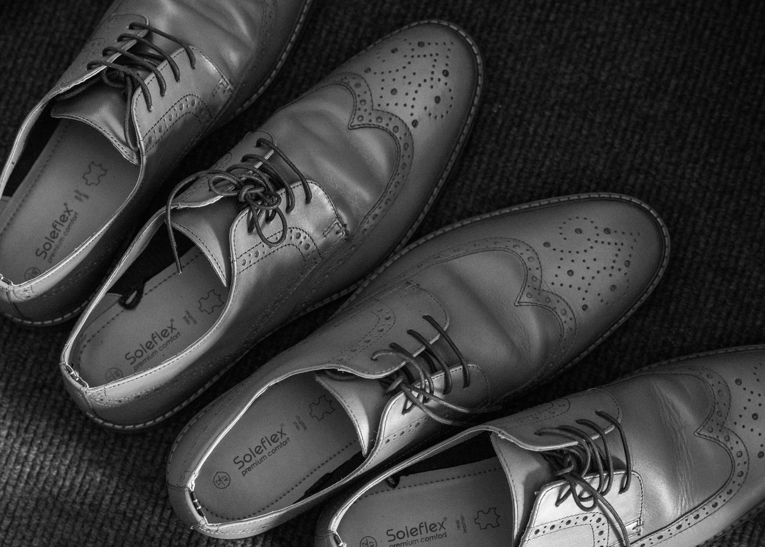 A black and white photograph of the grooms' shoes during morning prep in Worcestershire.