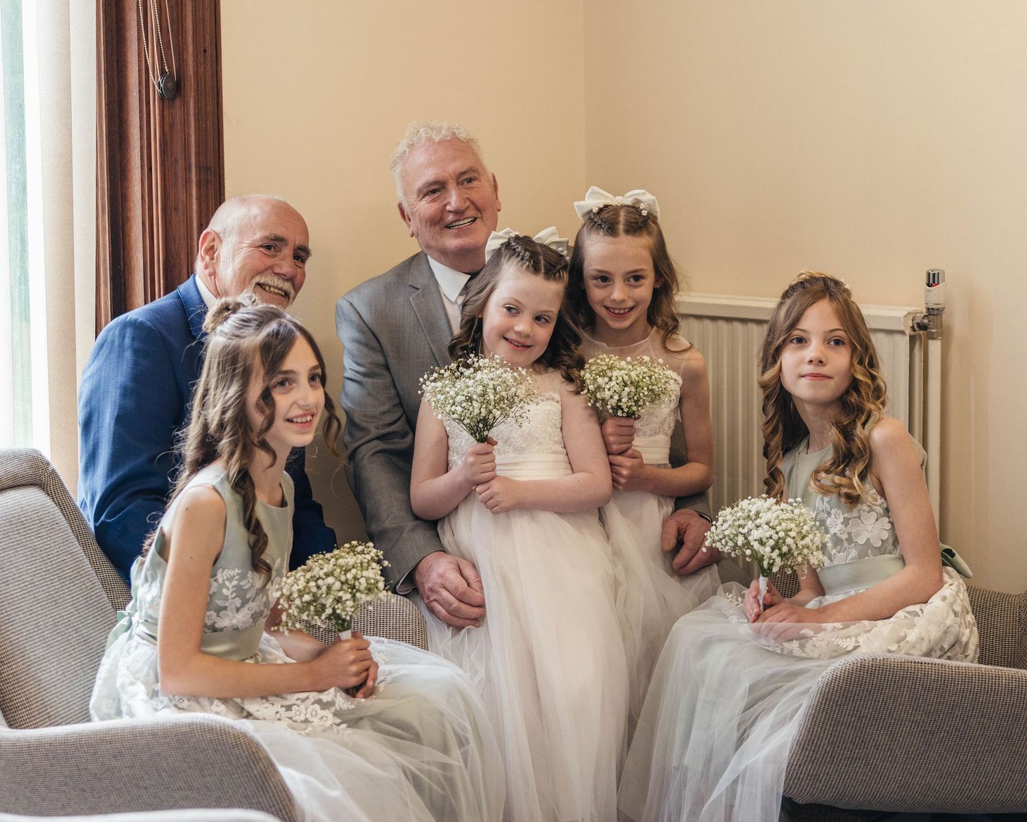Grandparents and their grandchildren posing before the wedding, captured by EvieSJPhotography.