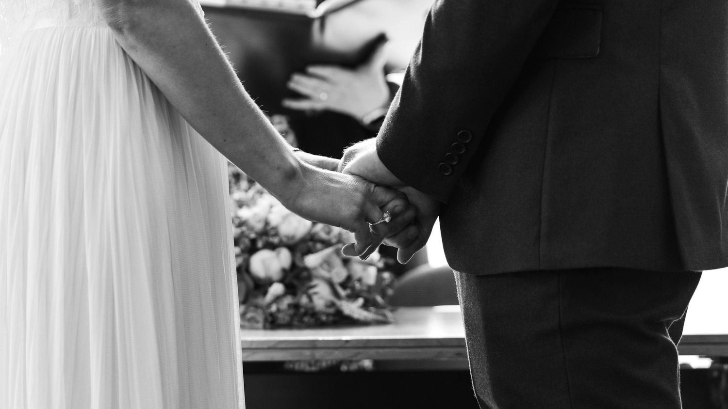 A bride and groom sharing a romantic moment during their ceremony, captured by EvieSJPhotography.
