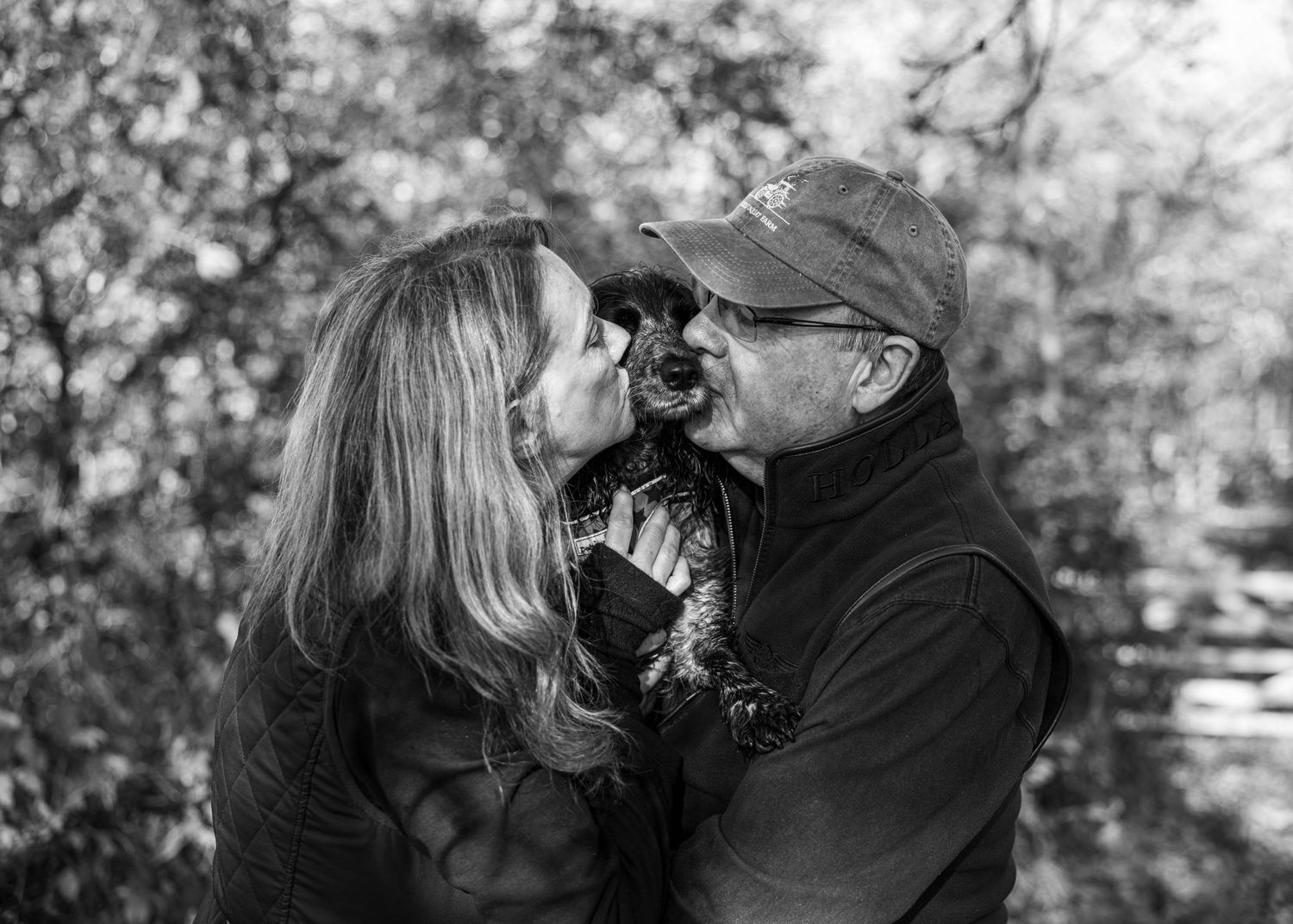 Couple kissing their dog during a relaxed lifestyle photoshoot in Worcestershire, photographed by EvieSJPhotography.