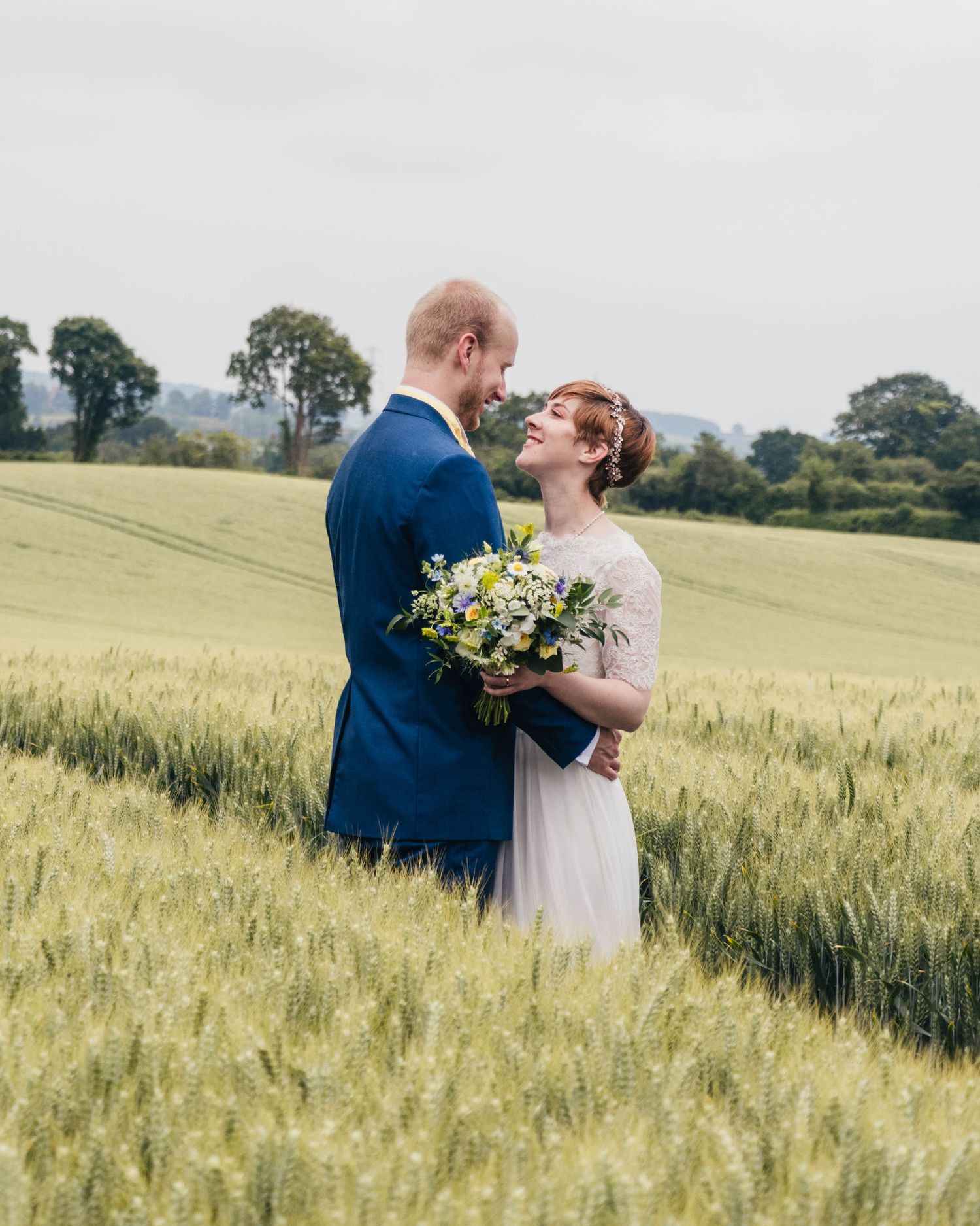 Bride and groom sharing a candid moment on their wedding day, captured in a relaxed documentary style by EvieSJPhotography.