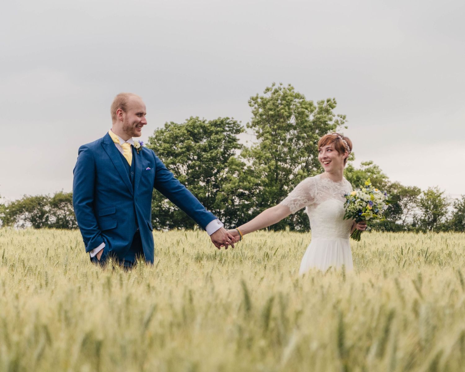 Bride and groom sharing a romantic moment on their wedding day, captured in a relaxed documentary style by EvieSJPhotography.