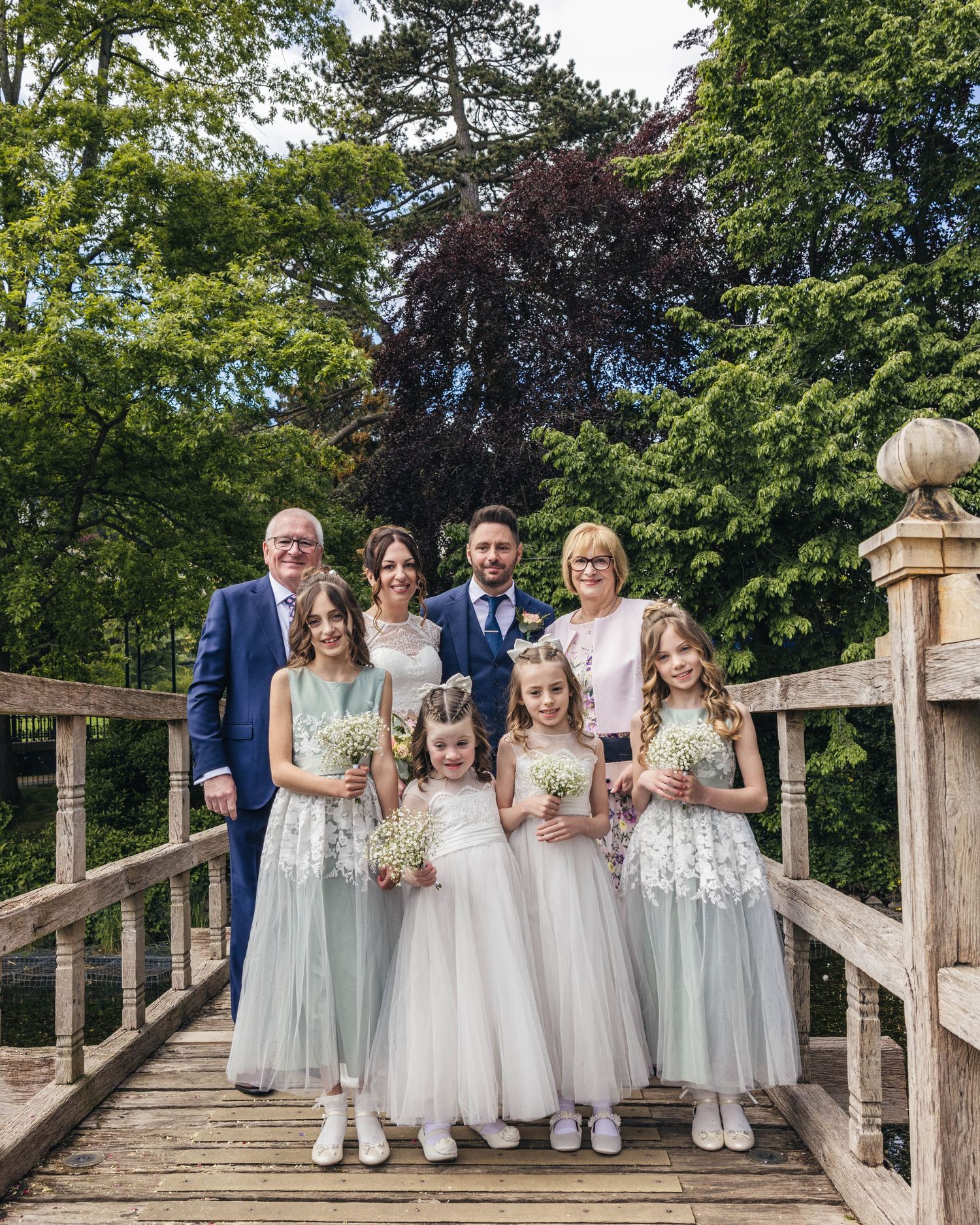 Bride groom, their parents and children on their wedding day, captured by EvieSJPhotography.