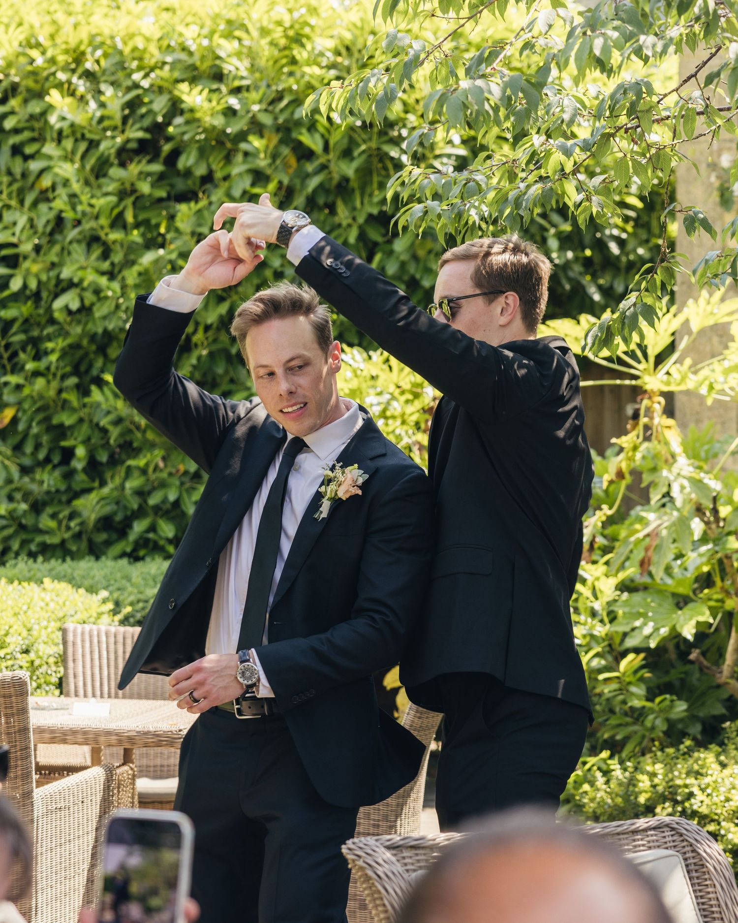 Groom and his brother dancing at a wedding.