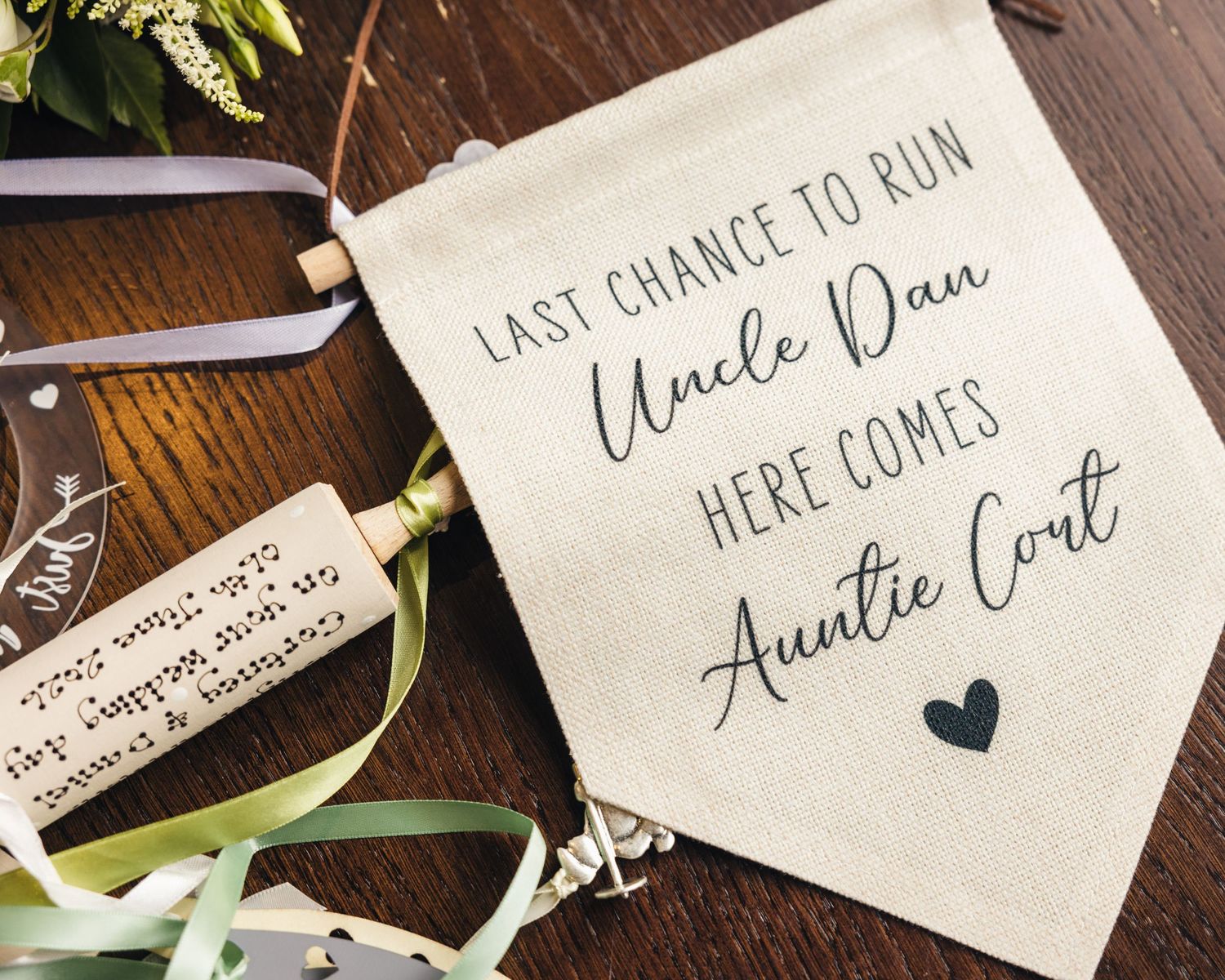 Personalised wedding sign celebrating the roles of Uncle Dan and Auntie Cortney.