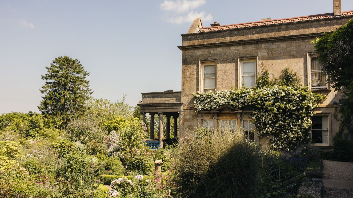 Outdoor wedding ceremony overlooking the Cotswold Hills at Kiftsgate Court Gardens