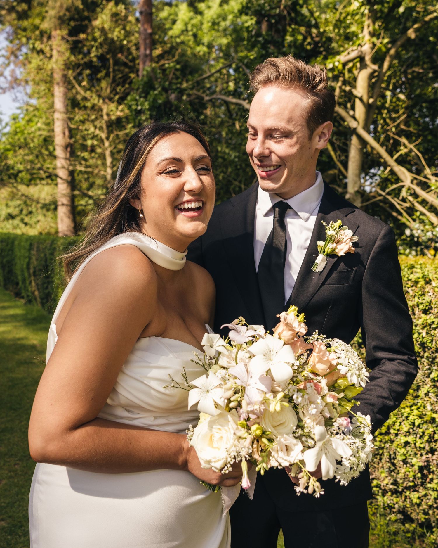 Bride and groom sharing private vows beneath the trees in the Cotswolds