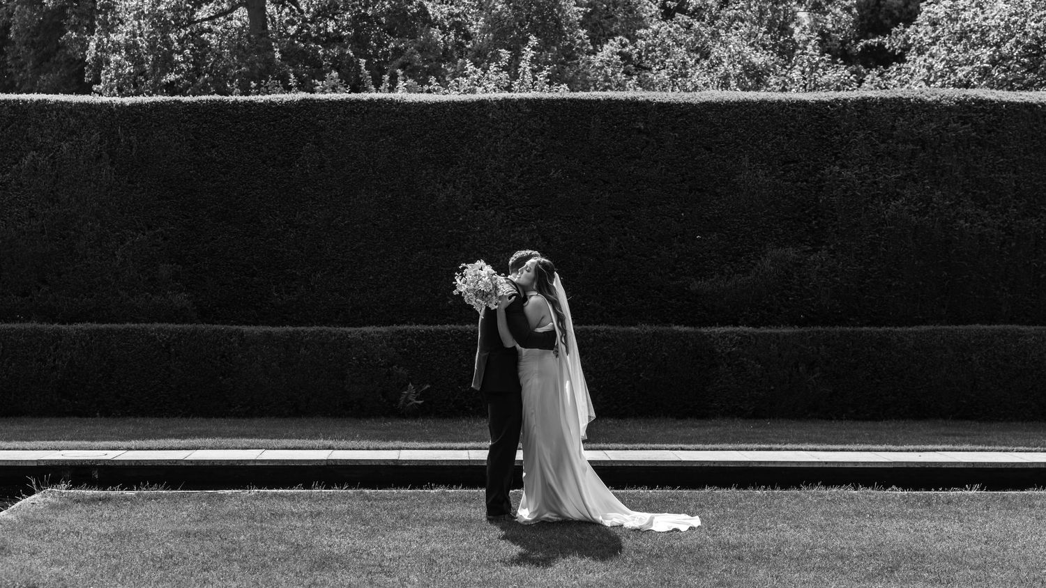 Bride and groom sharing a romantic moment on their wedding day, captured in a relaxed documentary style by EvieSJPhotography.