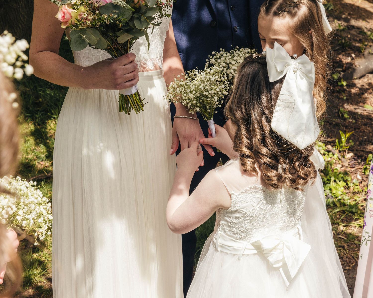 A daughter admiring her mother's wedding ring, captured by EvieSJPhotography in a documentary style.