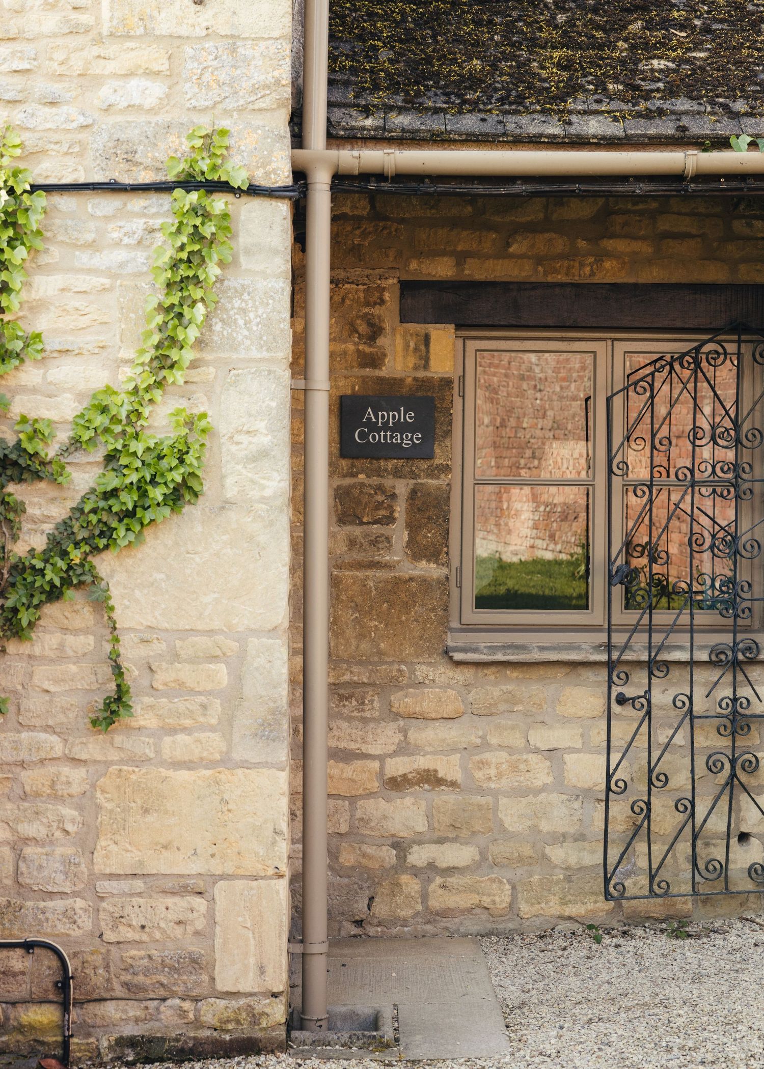 Outside Apple Cottage at Manor House Hotel in the Cotswolds, captured by EvieSJPhotography.