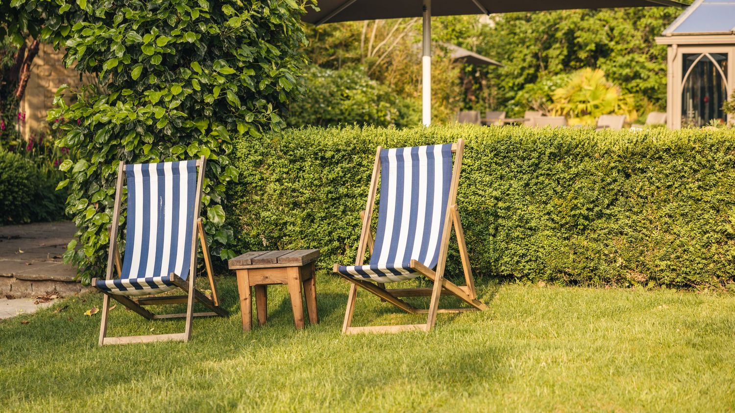 Deck chairs in a small garden at Manor House Hotel in the Cotswolds, captured by EVieSJPhotography.