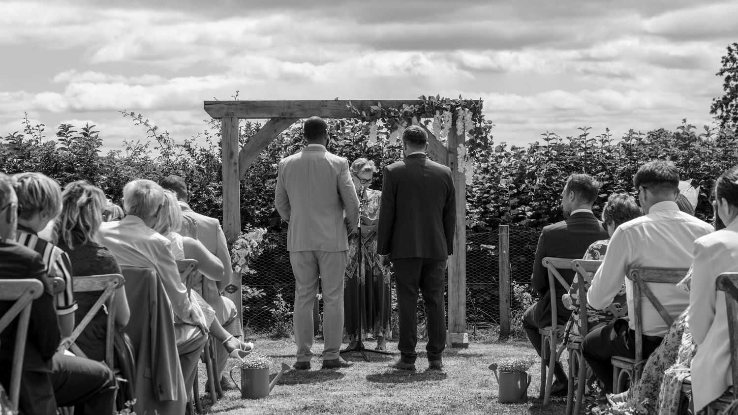 An emotional black-and-white photograph of Aaron and Jack during their wedding ceremony in Worcestershire.