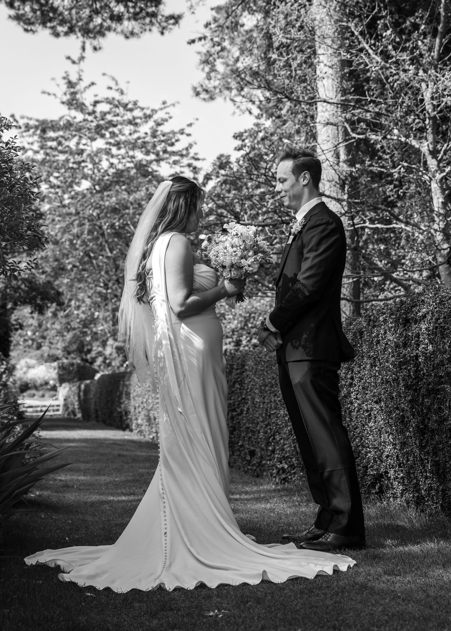 Bride and groom sharing private vows beneath the trees in the Cotswolds