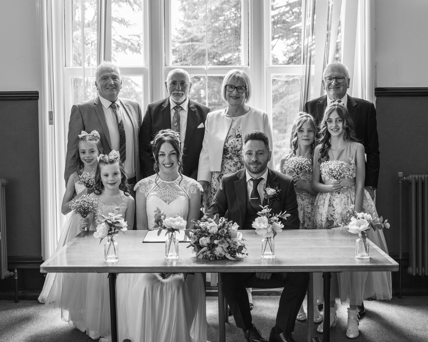 The wedding party having a group photo post-ceremony, captured by EvieSJPhotography.