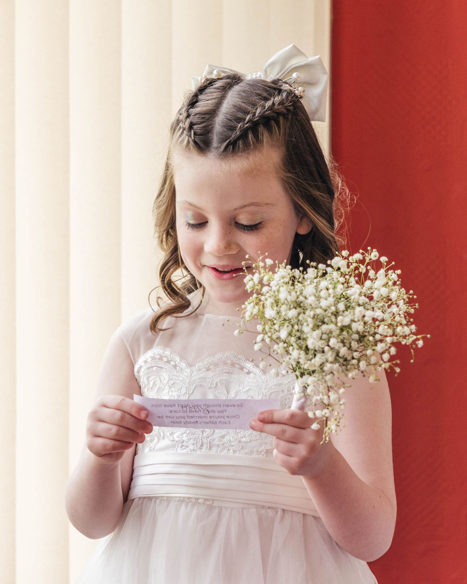 Bridesmaid reading a poem off a piece of paper during the ceremony, captured by EvieSJPhotography.