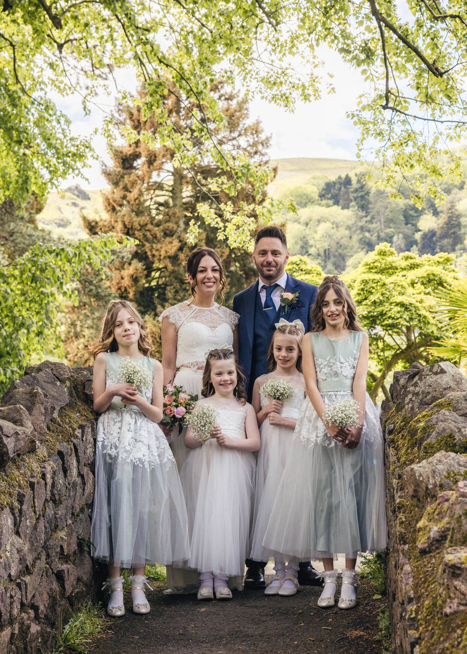 Bride and groom with their daughters, captured by EvieSJPhotography.