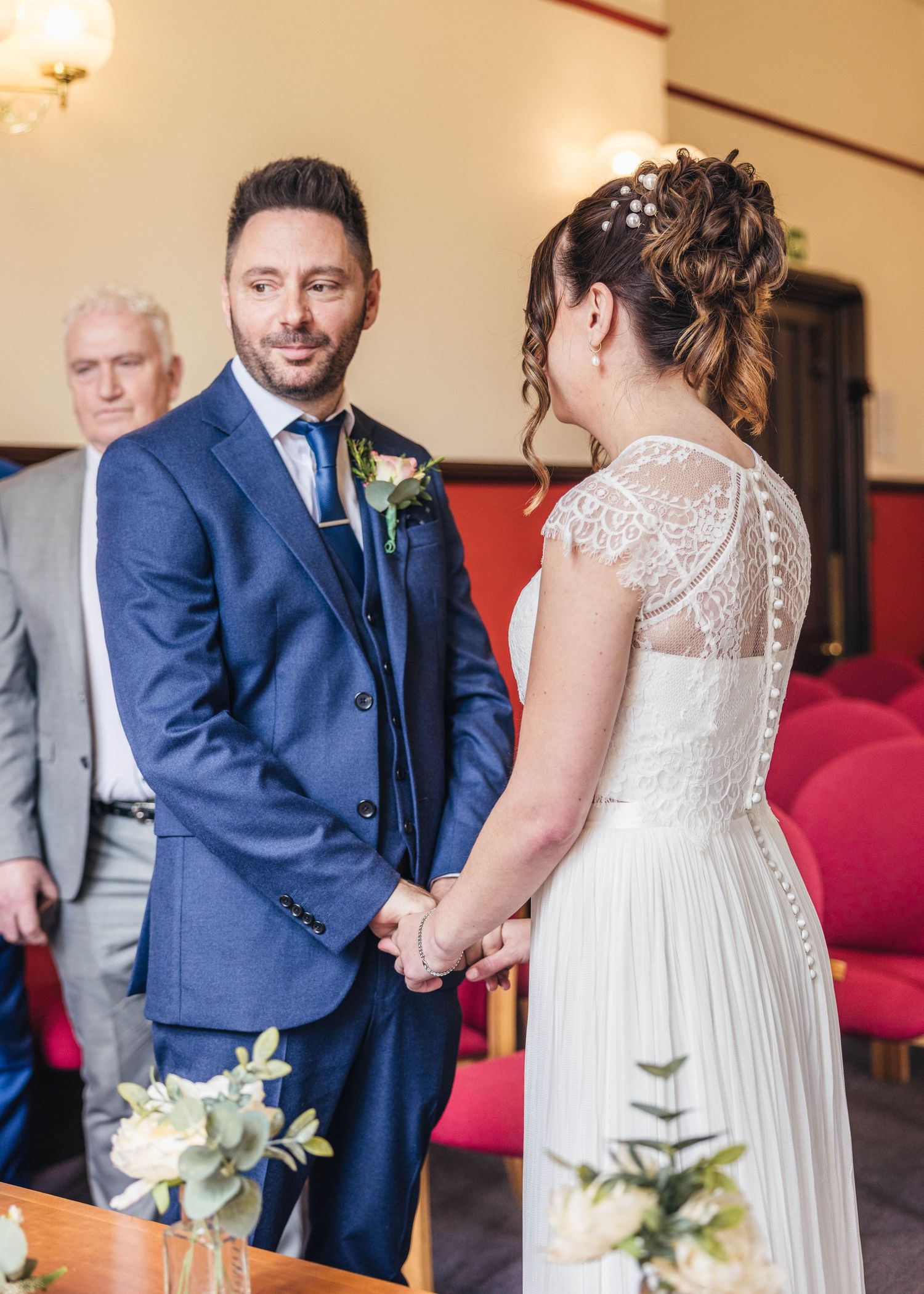 A bride and groom sharing a romantic moment during their ceremony, captured by EvieSJPhotography.
