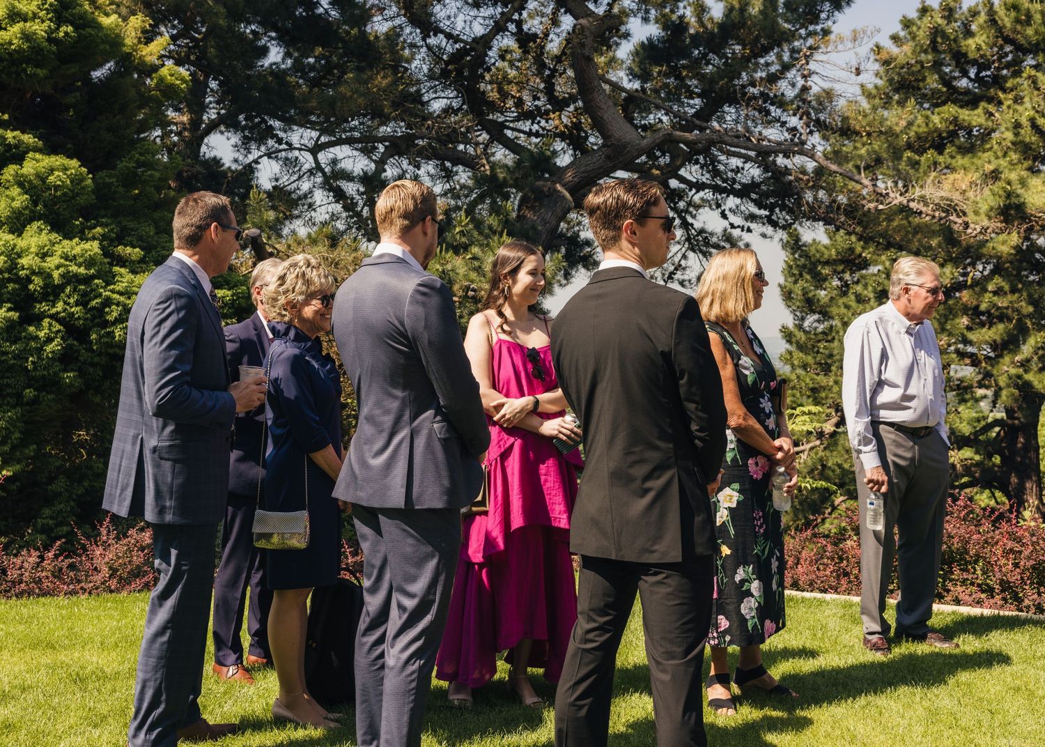 Guests watching an outdoor Cotswolds wedding ceremony in the gardens