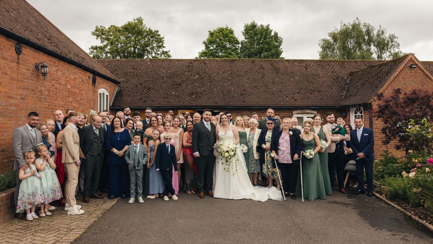 Cortney and Dan surrounded by family and friends for a group wedding photograph at Windmill Village Hotel.