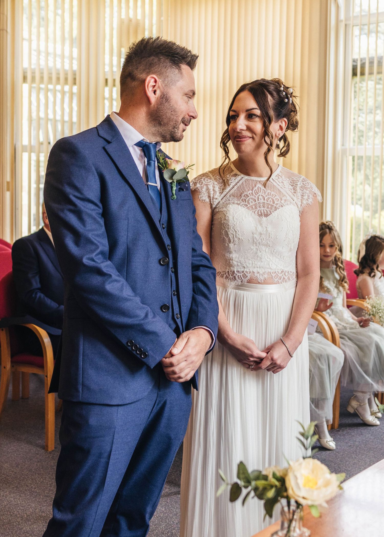 A bride and groom sharing a romantic moment during their ceremony, captured by EvieSJPhotography.