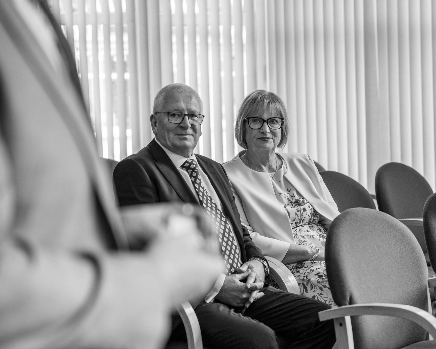 Bride's parents smiling watching their daughter get married, captured by EvieSJPhotography.