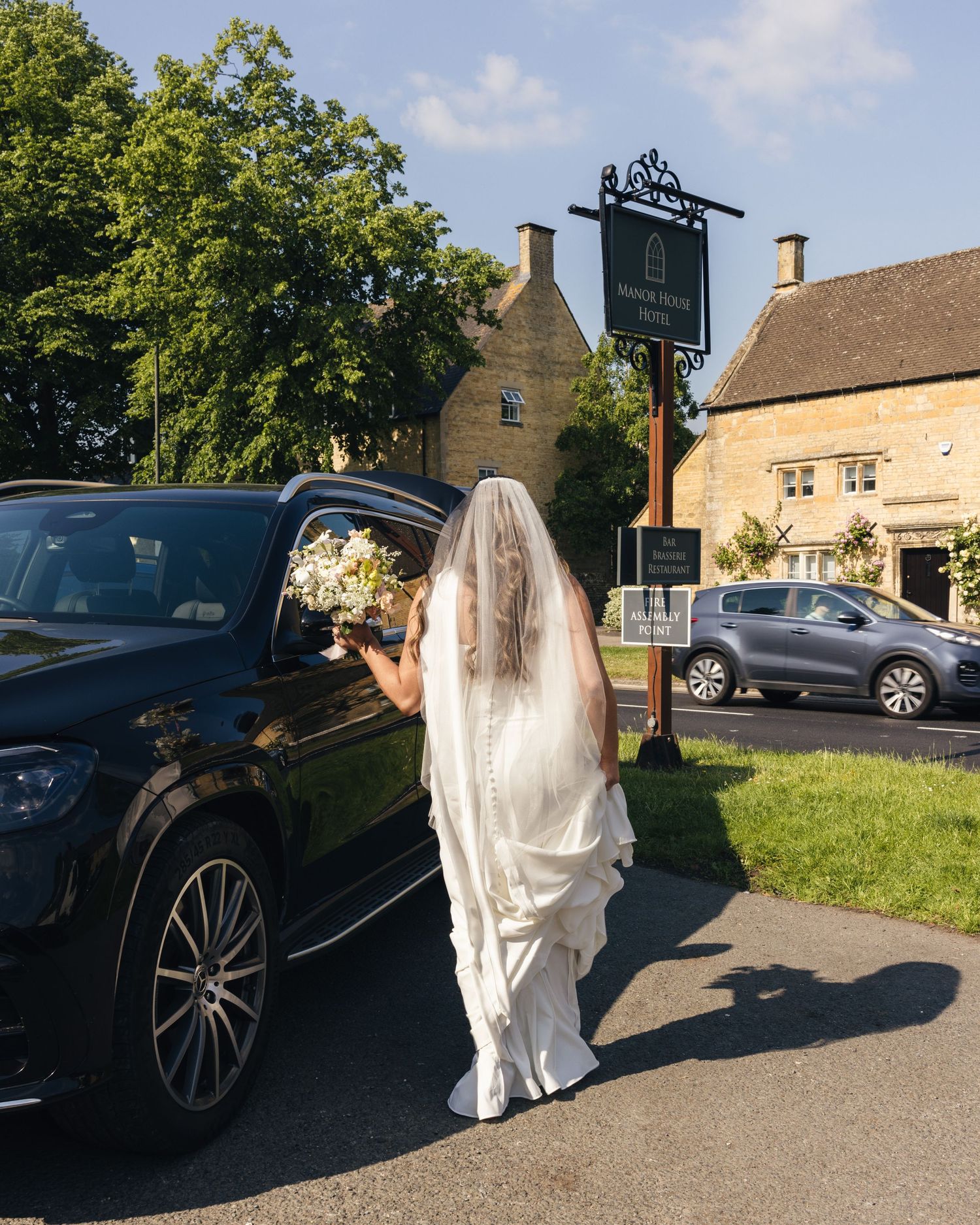 Bride walking out of a cottage to go to her wedding venue.