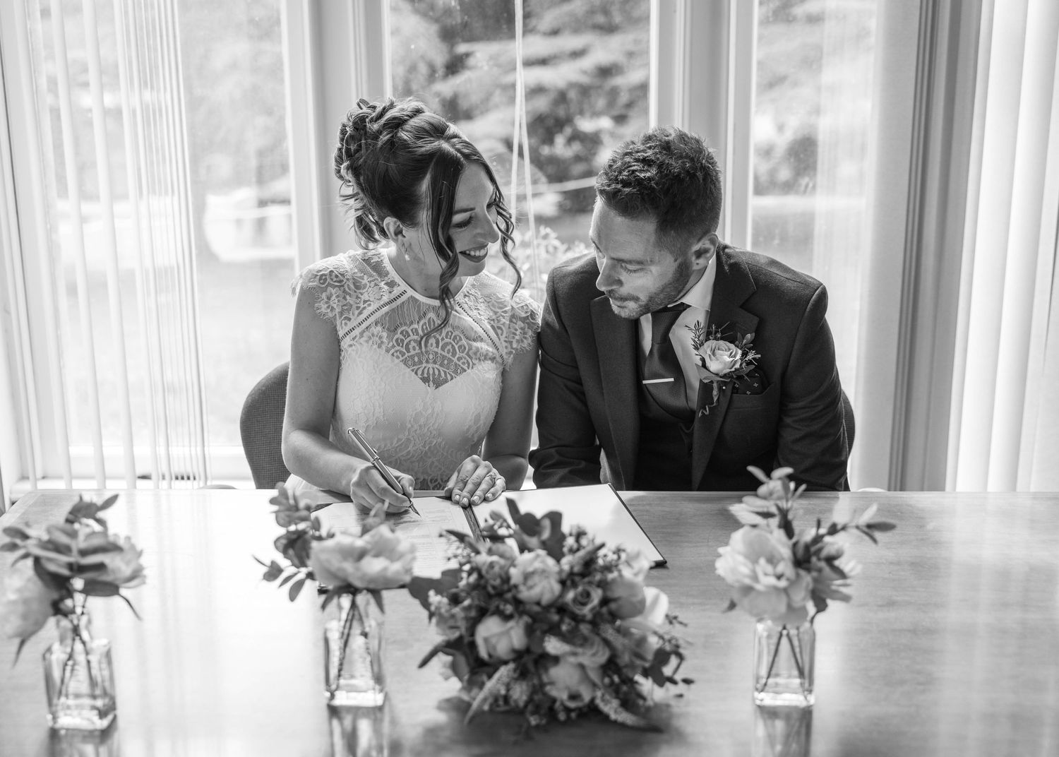 Bride and groom sharing a romantic moment on their wedding day, captured in a relaxed documentary style by EvieSJPhotography.
