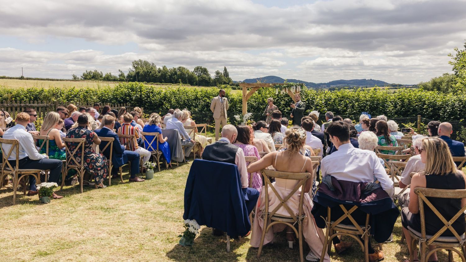 A wide angle view of guests awaiting the grooms on their wedding day at Rock Village Hall in Worcestershire.