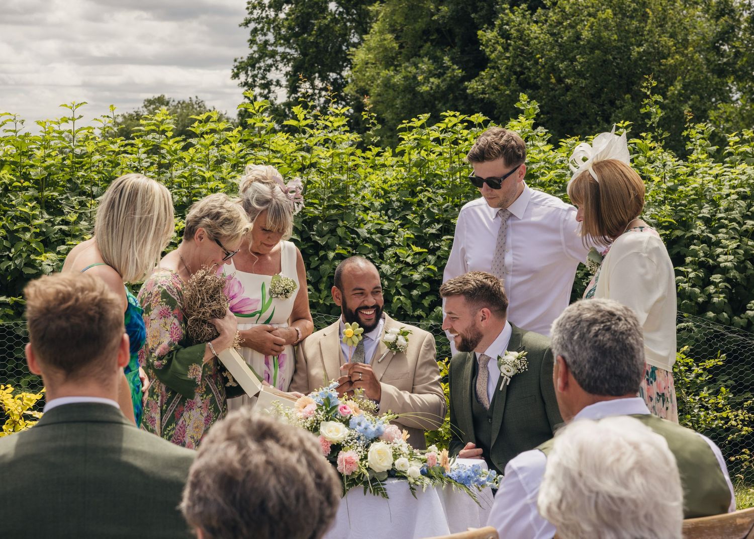 Aaron and Jack with their wedding witnesses, laughing at a comical pen from the wedding celebrant.