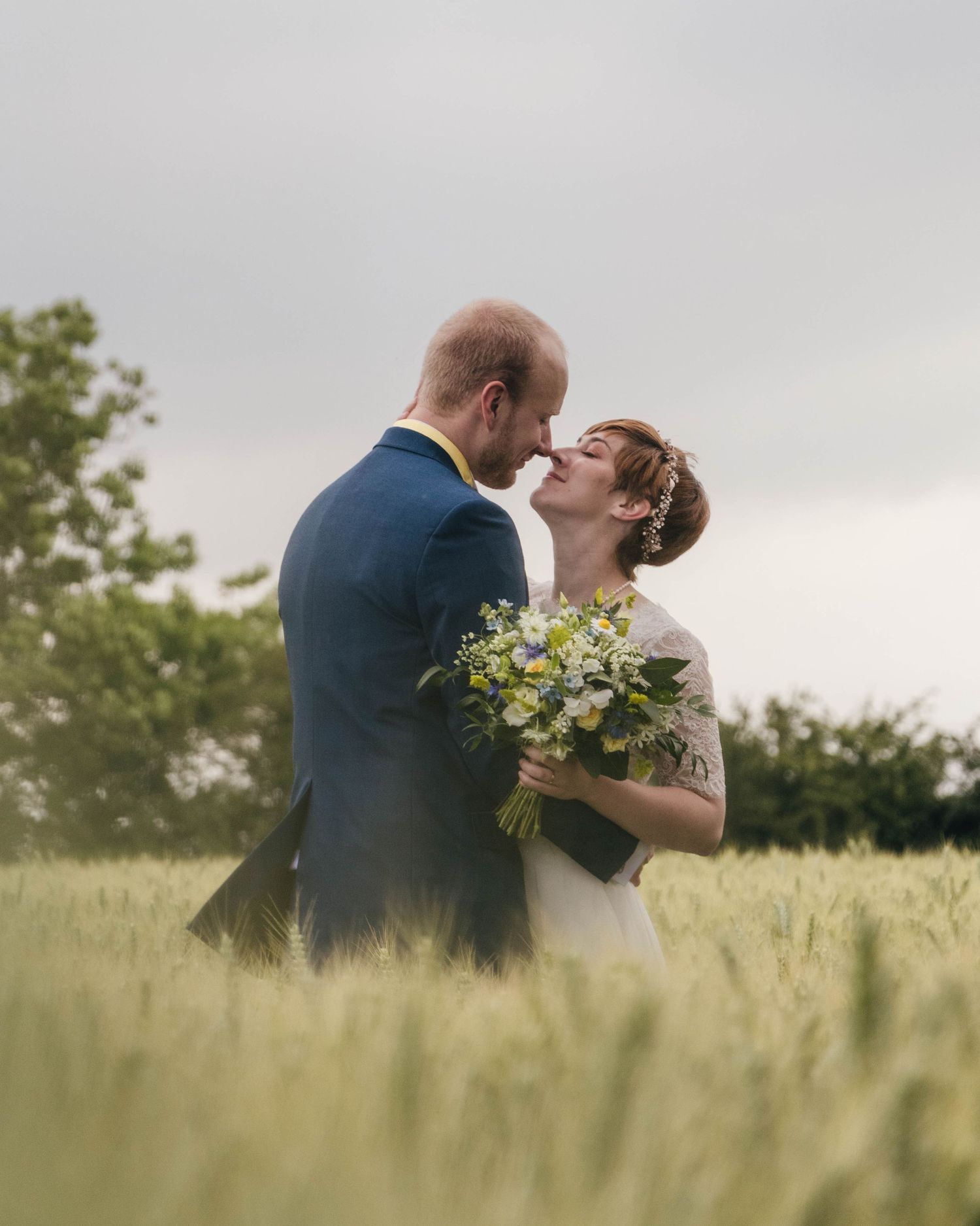 Bride and groom sharing a romantic moment on their wedding day, captured in a relaxed documentary style by EvieSJPhotography.