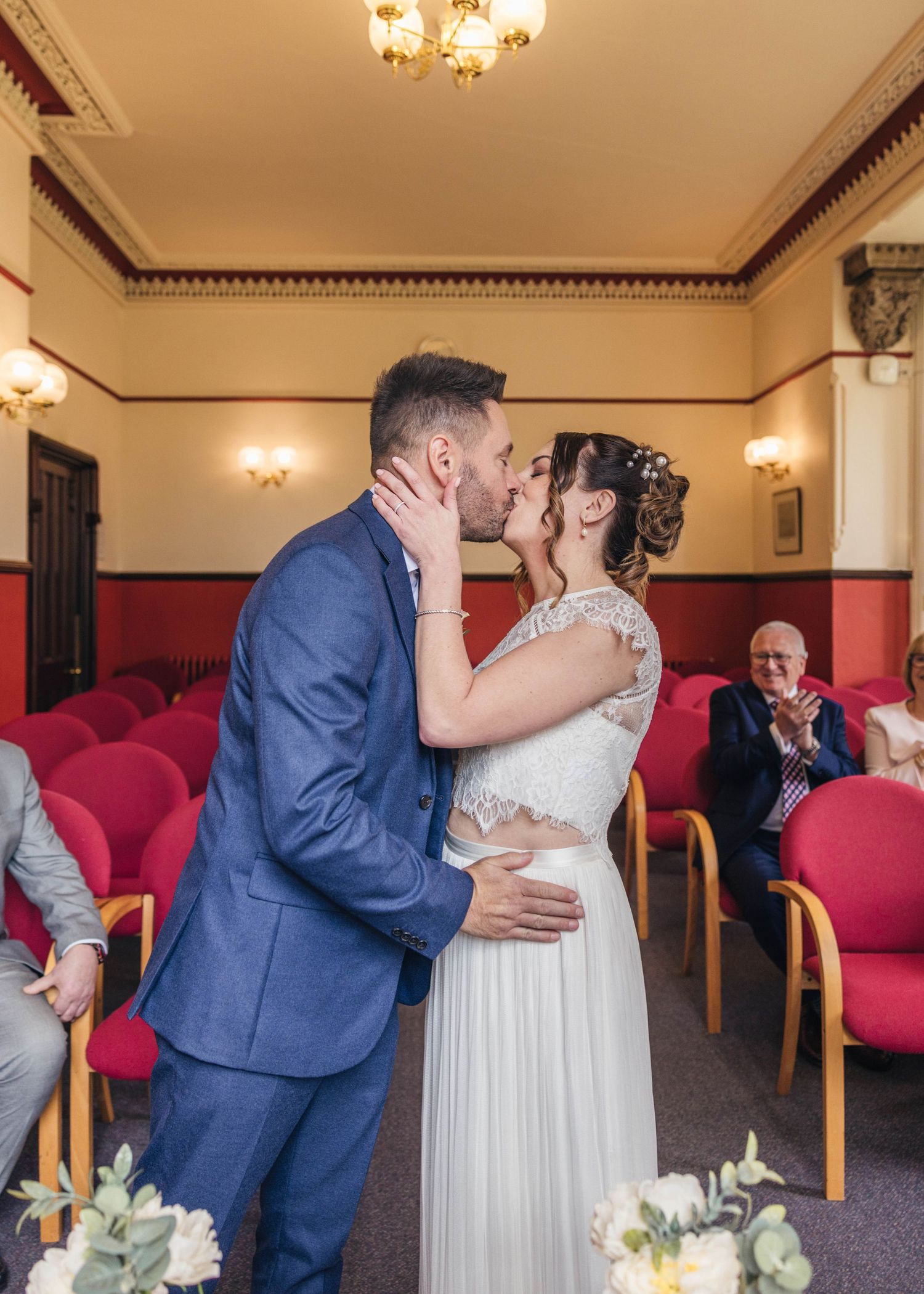 A bride and groom sharing a romantic kiss during their ceremony, captured by EvieSJPhotography.