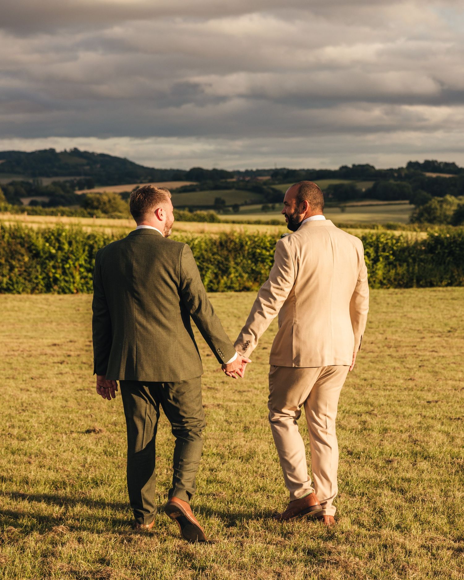 Aaron and Jack share a quiet moment together during golden-hour wedding portraits.