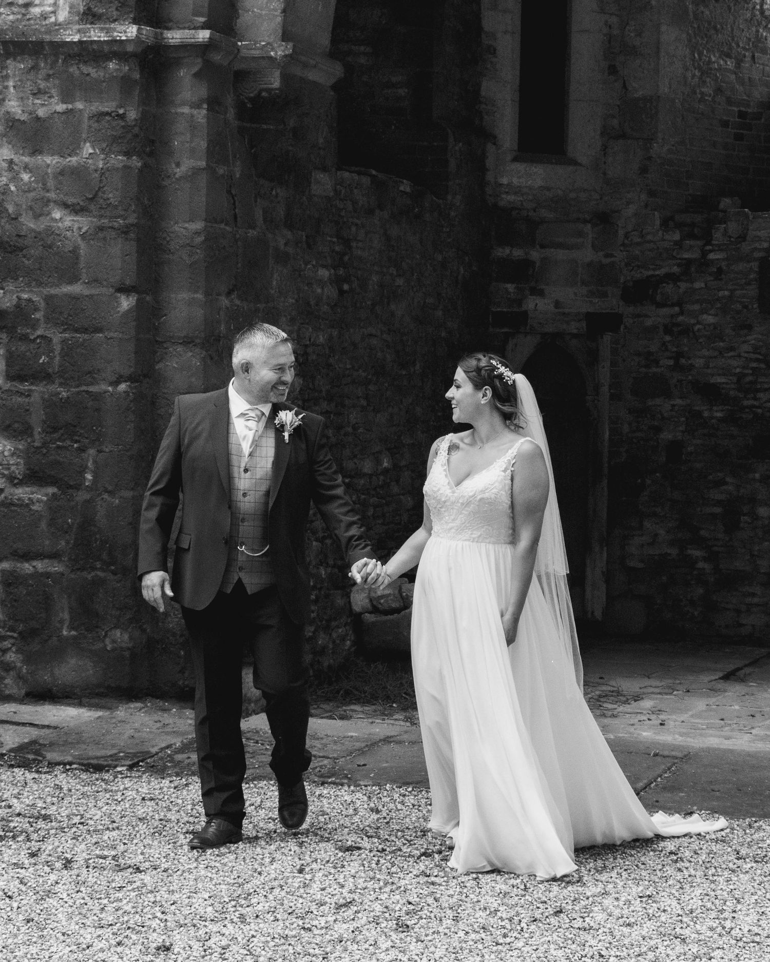 Bride and groom sharing a candid moment on their wedding day, captured in a relaxed documentary style by EvieSJPhotography.