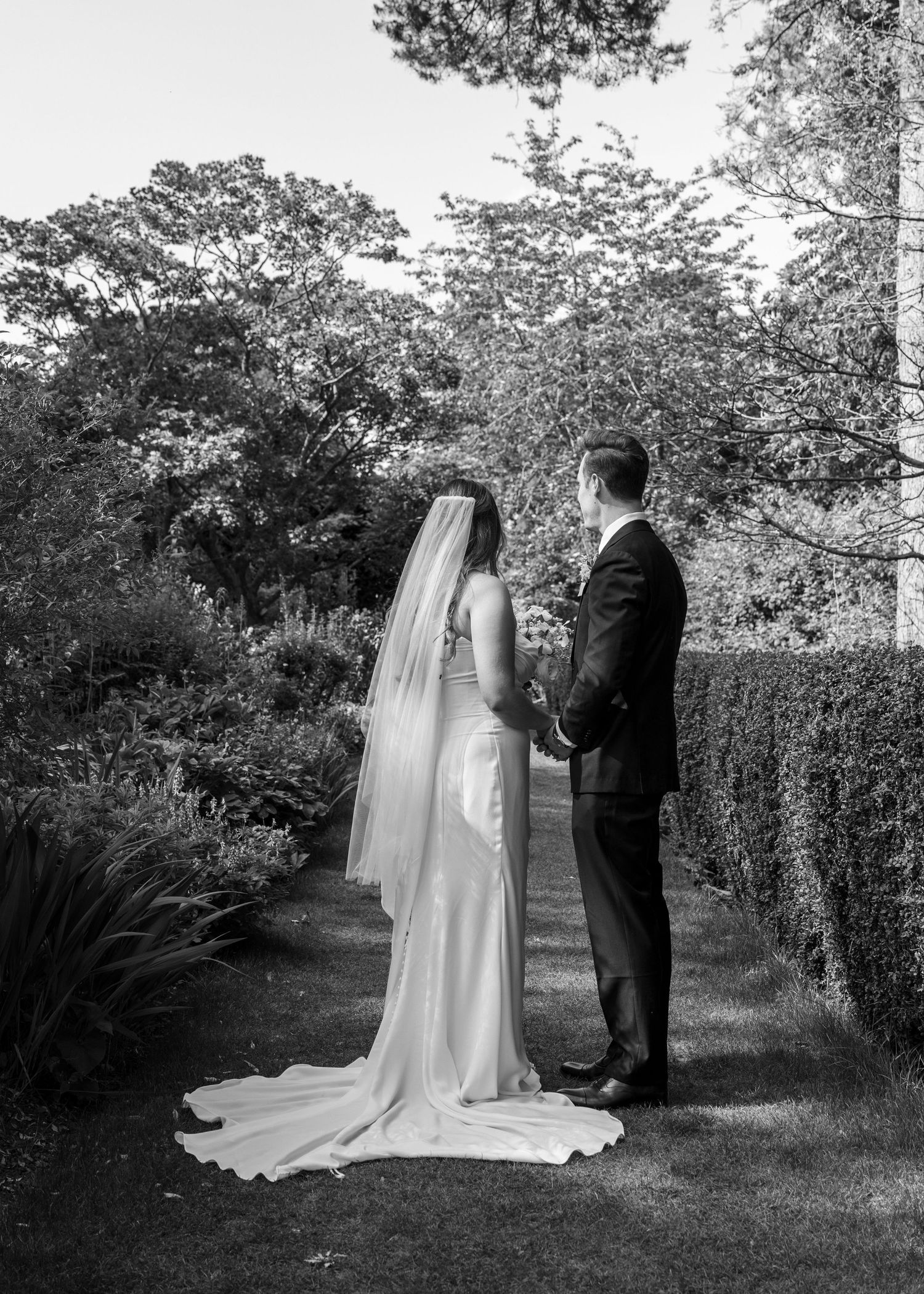 Bride and groom sharing private vows beneath the trees in the Cotswolds