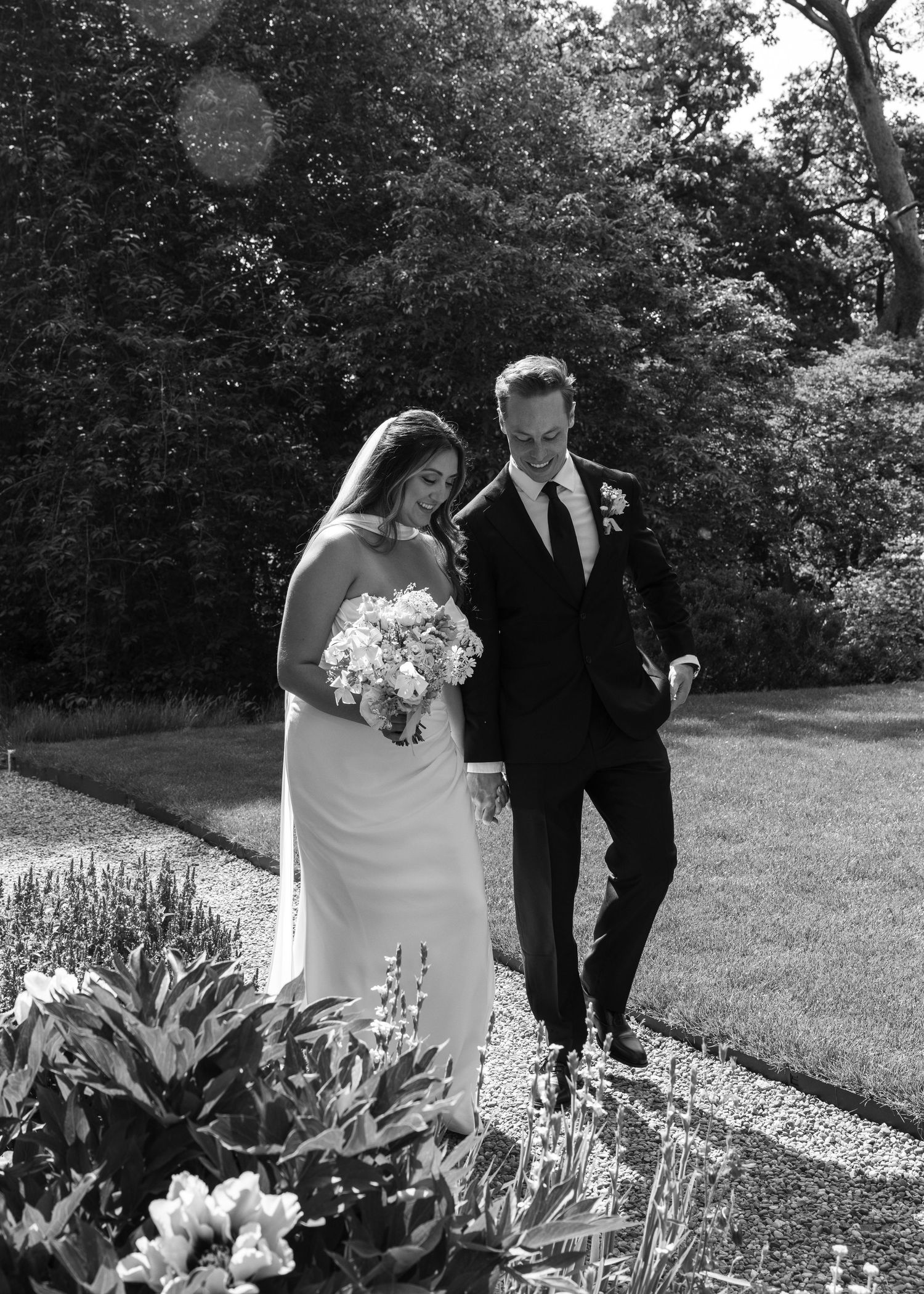 Bride and groom sharing a romantic moment on their wedding day, captured in a relaxed documentary style by EvieSJPhotography.