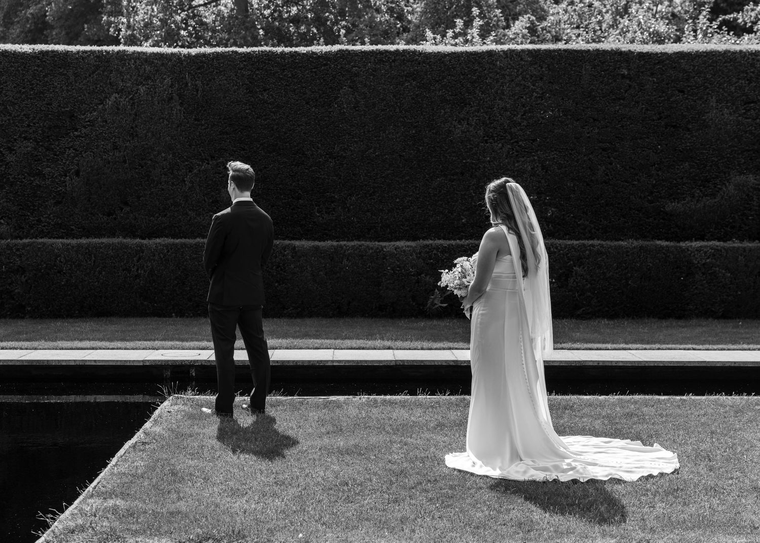 A bride and groom just before he turns around for the first look.